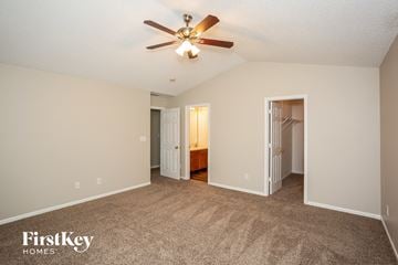 Noblesville house for rent - a spacious living room with carpet and a ceiling fan