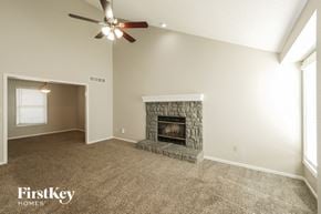 Belton house for rent - a living room with a fireplace and a ceiling fan