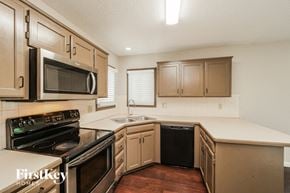 Belton house for rent - a kitchen with a stove and a sink and a microwave