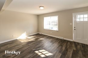 Monroe house for rent - A room with wooden floors and a white door.