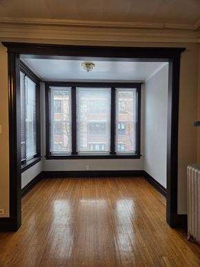 Chicago apartment for rent - A room with a window and a radiator on the floor.
