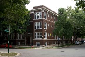 Chicago apartment for rent - A red car is parked on the side of the street.