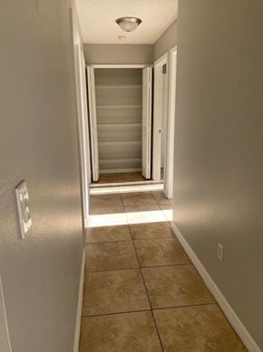 Orlando house for rent - a hallway with a staircase and a door to a closet