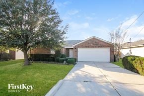 Conroe house for rent - a home with a white garage door and a driveway