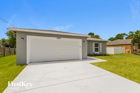 Port St. Lucie house for rent - a home with a white garage door and a driveway