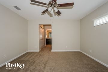 Port St. Lucie house for rent - a living room with carpet and a ceiling fan