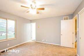 Indianapolis house for rent - a bedroom with a ceiling fan and a closet