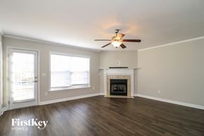 Clemmons house for rent - a living room with a fireplace and a ceiling fan