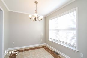 Clemmons house for rent - a dining room with a large window and a chandelier