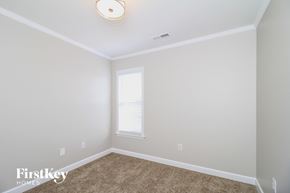 Clemmons house for rent - a bedroom with white walls and carpet and a window