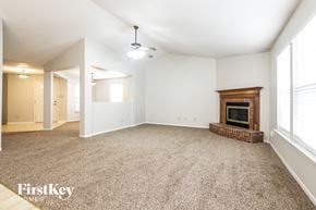 Avon house for rent - A spacious living room with a fireplace and carpeted floor.