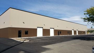 Yakima apartment for rent - a brown and white building with a parking lot