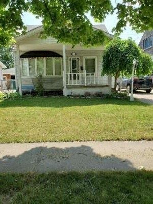Windsor house for rent - A white house with a porch and a tree in front.