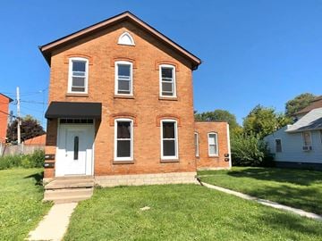 Windsor apartment for rent - A red brick house with a white door and windows.