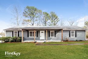 Lawrenceville house for rent - a blue house with a white door and a green lawn