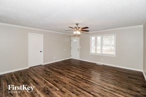 Lawrenceville house for rent - the living room of an empty house with a ceiling fan