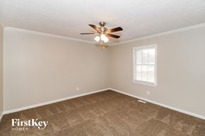 Lawrenceville house for rent - a bedroom with carpet and a ceiling fan