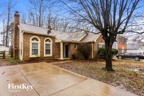 Charlotte house for rent - A brick house with a tree in front of it.