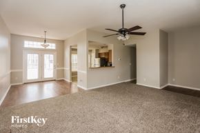 Charlotte house for rent - A spacious room with a carpeted floor and a ceiling fan.