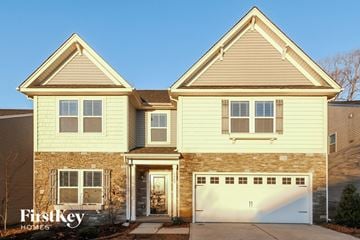 Gastonia house for rent - a yellow house with a white garage door