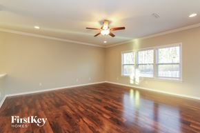 Gastonia house for rent - a living room with wood floors and a ceiling fan