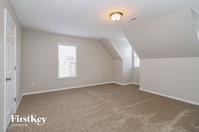 Winston Salem house for rent - the bedroom of an attic with carpet and a window