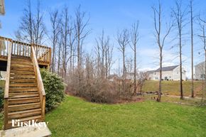 Winston Salem house for rent - a backyard with a wooden deck and some trees