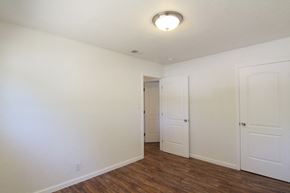 Sacramento house for rent - a bedroom with white walls and wood flooring and a closet