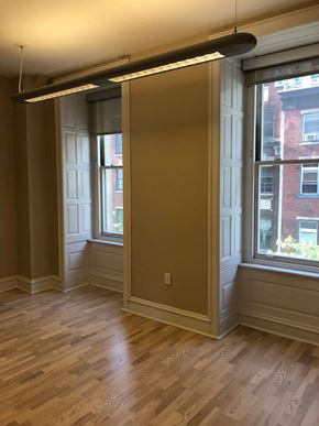 Philadelphia apartment for rent - a living room with two windows and a wooden floor