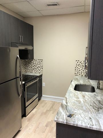 Philadelphia apartment for rent - a kitchen with stainless steel appliances and a marble counter top