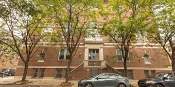 Philadelphia apartment for rent - the front of a brick building with cars parked in front
