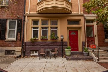 Philadelphia apartment for rent - the front of a house with a patio and a red door
