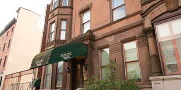 Philadelphia apartment for rent - a building with a green awning in front of it