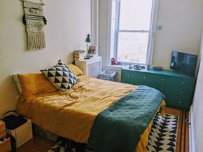 Philadelphia apartment for rent - a bedroom with a bed and a dresser and a window