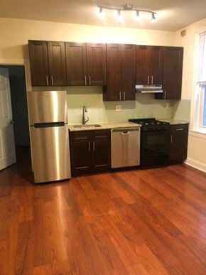 Philadelphia apartment for rent - a kitchen with stainless steel appliances and wooden floors