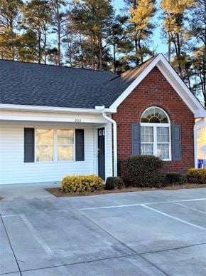 Nashville apartment for rent - A small house with a red brick chimney and a white door.