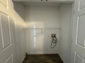 Rocky Mount apartment for rent - A white closet with a wooden floor and a hanger rack.