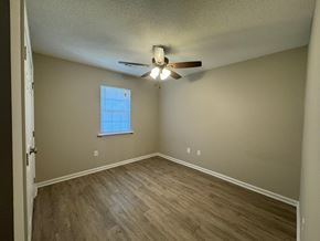Rocky Mount apartment for rent - A room with a ceiling fan and a window with blinds.