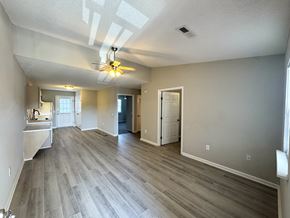 Rocky Mount apartment for rent - A spacious room with a ceiling fan and lighting fixture.