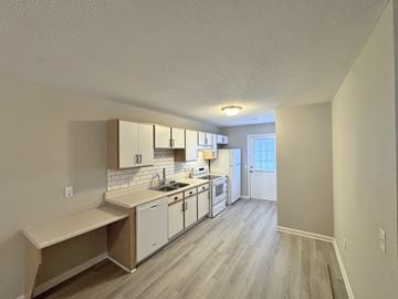 Rocky Mount apartment for rent - A kitchen with white cabinets and a window.