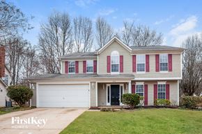 Charlotte house for rent - a house with red shutters and a white garage door