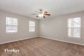 Charlotte house for rent - a bedroom with carpet and a ceiling fan