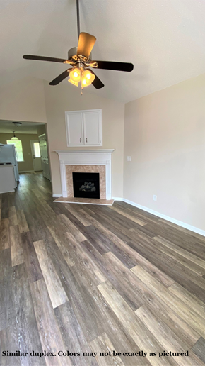 Rocky Mount apartment for rent - A room with a fireplace and a ceiling fan.