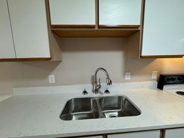 Rocky Mount apartment for rent - a kitchen with a sink and some white cabinets
