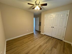 Rocky Mount apartment for rent - an empty living room with wood floors and a ceiling fan
