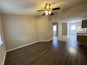 Rocky Mount apartment for rent - A room with a ceiling fan and wooden flooring.