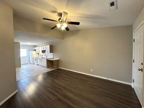 Rocky Mount apartment for rent - A room with a ceiling fan and wooden flooring.