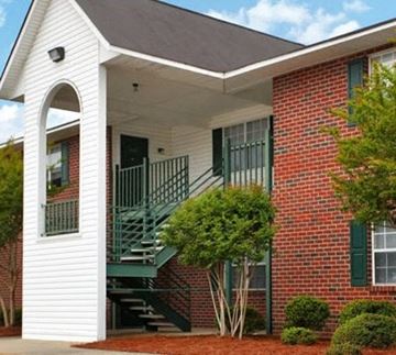 Nashville apartment for rent - the front of a brick house with a porch and stairs