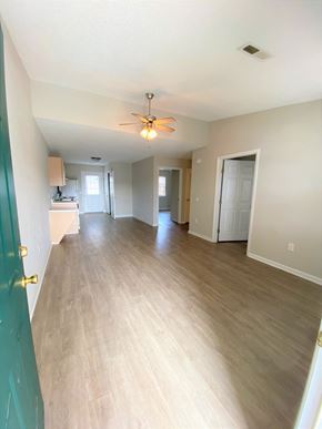 Nashville apartment for rent - an empty living room with wood floors and a ceiling fan