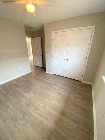 Nashville apartment for rent - a living room with wood flooring and a white door